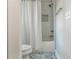 Clean bathroom featuring white subway tile shower, toilet, and patterned blue flooring at 1555 Steele Nw Dr, Atlanta, GA 30309