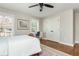Bright bedroom featuring hardwood floors, ceiling fan, and charming built-in desk near a sunny window at 1555 Steele Nw Dr, Atlanta, GA 30309