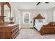 Bedroom featuring a vintage dresser, bedside table, wooden bed frame, and carpet at 1555 Steele Nw Dr, Atlanta, GA 30309