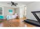Hardwood bedroom features a ceiling fan, comfortable decor, and a treadmill fitness area at 1555 Steele Nw Dr, Atlanta, GA 30309
