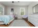Bright bedroom featuring hardwood floors, ample sunlight, and a stylish decor with ample storage at 1555 Steele Nw Dr, Atlanta, GA 30309