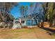 Inviting blue home with dormer windows, a fenced yard and mature trees at 1555 Steele Nw Dr, Atlanta, GA 30309