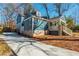 View of a blue home with a stone foundation, and a long driveway at 1555 Steele Nw Dr, Atlanta, GA 30309