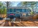 Rear exterior view of a two-story home with a deck and landscaped backyard at 1555 Steele Nw Dr, Atlanta, GA 30309