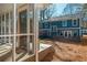 Back exterior view with a screened porch and a tiered backyard at 1555 Steele Nw Dr, Atlanta, GA 30309