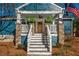 Cozy front porch with stone columns, hanging plants, and a ceiling fan at 1555 Steele Nw Dr, Atlanta, GA 30309