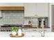 Kitchen with stainless steel appliances, patterned backsplash, and wood accents at 1555 Steele Nw Dr, Atlanta, GA 30309