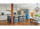 Modern kitchen with a blue island, white cabinets, stainless steel appliances, and a wooden beam at 1555 Steele Nw Dr, Atlanta, GA 30309