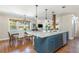 Open-concept kitchen featuring a large island, stainless steel appliances, and hardwood floors at 1555 Steele Nw Dr, Atlanta, GA 30309