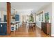 Open-concept kitchen and dining area with hardwood floors and a center support beam at 1555 Steele Nw Dr, Atlanta, GA 30309