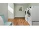 Well-lit laundry room with hardwood floors and modern washer and dryer units at 1555 Steele Nw Dr, Atlanta, GA 30309