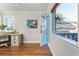 Bright office area featuring hardwood floors, a white desk, and a door to the outside at 1555 Steele Nw Dr, Atlanta, GA 30309