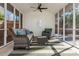 Cozy screened porch featuring stylish furniture and a ceiling fan for ultimate relaxation and comfort at 1555 Steele Nw Dr, Atlanta, GA 30309