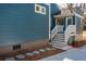 Charming side entrance with blue siding, white trim, and stone stepping pavers at 1555 Steele Nw Dr, Atlanta, GA 30309
