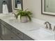 Bathroom vanity with double sinks, white countertop, gray cabinets, and modern fixtures at 1555 Steele Nw Dr, Atlanta, GA 30309