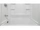 Bathroom features a white bathtub and shower combination with built-in shelves for storage at 3000 Fern Valley Sw Dr, Marietta, GA 30008