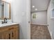 Bathroom vanity in warm wood with a modern faucet and hardware, adjacent to the carpeted bedroom at 3000 Fern Valley Sw Dr, Marietta, GA 30008