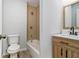 Updated bathroom featuring a tub-shower combo and a wood-toned vanity at 3000 Fern Valley Sw Dr, Marietta, GA 30008