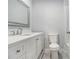 Bathroom includes a white single sink vanity with a mirror and a toilet with a white tile floor at 3000 Fern Valley Sw Dr, Marietta, GA 30008