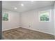 Bedroom with carpet, two windows providing natural light, and painted in a neutral gray at 3000 Fern Valley Sw Dr, Marietta, GA 30008