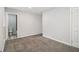 Bedroom with carpeted floors, access to an ensuite bathroom, neutral gray paint, and white trim at 3000 Fern Valley Sw Dr, Marietta, GA 30008