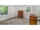 Bright bedroom with carpet flooring, two windows, and dresser at 3000 Fern Valley Sw Dr, Marietta, GA 30008