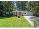 Charming single-story home featuring a inviting front porch and a well-maintained lawn at 3000 Fern Valley Sw Dr, Marietta, GA 30008