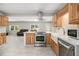 Modern kitchen featuring wooden cabinets, stainless steel appliances, and open sight-lines to living areas at 3000 Fern Valley Sw Dr, Marietta, GA 30008