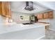 Modern kitchen features white counters, stainless steel appliances, light wood cabinets, and a sleek range hood at 3000 Fern Valley Sw Dr, Marietta, GA 30008