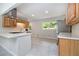 The kitchen features tile floors, white counters, light wood cabinets, stainless steel appliances, and a kitchen island at 3000 Fern Valley Sw Dr, Marietta, GA 30008