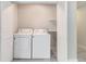 Laundry closet contains a side-by-side washer and dryer, shelves, and bifold doors for easy access at 3000 Fern Valley Sw Dr, Marietta, GA 30008