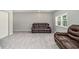 Spacious living room with gray paint, light wood-look flooring and comfortable leather seating at 3000 Fern Valley Sw Dr, Marietta, GA 30008