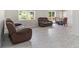 Open-concept living area with modern wood-look floors, a dining table, and a leather sofa at 3000 Fern Valley Sw Dr, Marietta, GA 30008