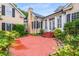 Exterior view features a spacious brick patio surrounded by lush landscaping at 3786 Turnberry Ct, Duluth, GA 30096