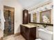 Bathroom with granite vanity, tiled shower with glass door and decorative light fixture at 3786 Turnberry Ct, Duluth, GA 30096