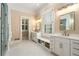 Bright bathroom featuring double sinks, shower, and marble floors at 3786 Turnberry Ct, Duluth, GA 30096