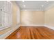 Well-lit bedroom featuring hardwood floors and large windows with plantation shutters at 3786 Turnberry Ct, Duluth, GA 30096