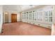 Brick floored sunroom featuring window shutters, and a beamed ceiling at 3786 Turnberry Ct, Duluth, GA 30096
