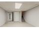 A spacious unfinished basement with tile floors, stairs, and access to other rooms at 5073 Leland Dr, Stone Mountain, GA 30083