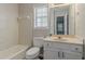 Tiled bathroom with tub, sink, and window at 5073 Leland Dr, Stone Mountain, GA 30083