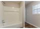 Bathroom featuring a white tiled shower and a window for natural light at 5073 Leland Dr, Stone Mountain, GA 30083