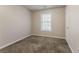 Empty bedroom with neutral walls, plush carpet and a bright window at 5073 Leland Dr, Stone Mountain, GA 30083