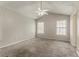 Empty bedroom with plush carpet, two windows, and neutral paint at 5073 Leland Dr, Stone Mountain, GA 30083