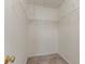 Walk-in closet featuring carpet flooring, shelving and a door at 5073 Leland Dr, Stone Mountain, GA 30083