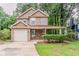 Charming two-story home with a covered front porch and a well-maintained lawn at 5073 Leland Dr, Stone Mountain, GA 30083