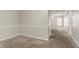 Hallway with neutral paint and carpet leads to a bright window and open spaces at 5073 Leland Dr, Stone Mountain, GA 30083