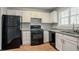 Well-lit kitchen with white cabinets, granite countertops, and modern appliances at 5073 Leland Dr, Stone Mountain, GA 30083