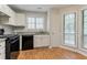 Bright kitchen featuring white cabinets, granite countertops, and stainless steel appliances at 5073 Leland Dr, Stone Mountain, GA 30083