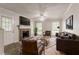 Cozy living room featuring a brick fireplace, ceiling fan and a comfortable seating area at 5073 Leland Dr, Stone Mountain, GA 30083