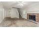 Living room featuring a brick fireplace, carpet, ceiling fan, and staircase at 5073 Leland Dr, Stone Mountain, GA 30083